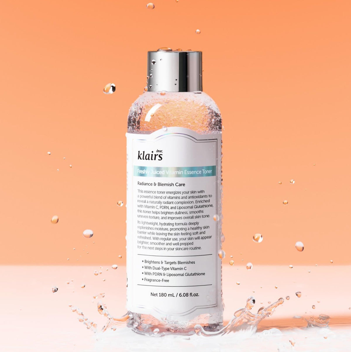 KLAIRS Freshly Juiced Vitamin Blemish Toner 180ml bottle against orange background