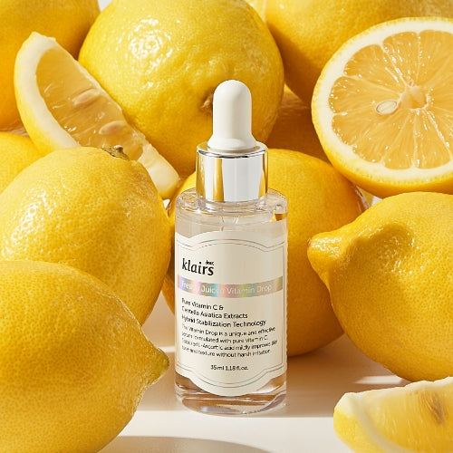 KLAIRS Freshly Juiced Vitamin Drop 35ml serum bottle surrounded by fresh lemons, highlighting vitamin C benefits for skin.
