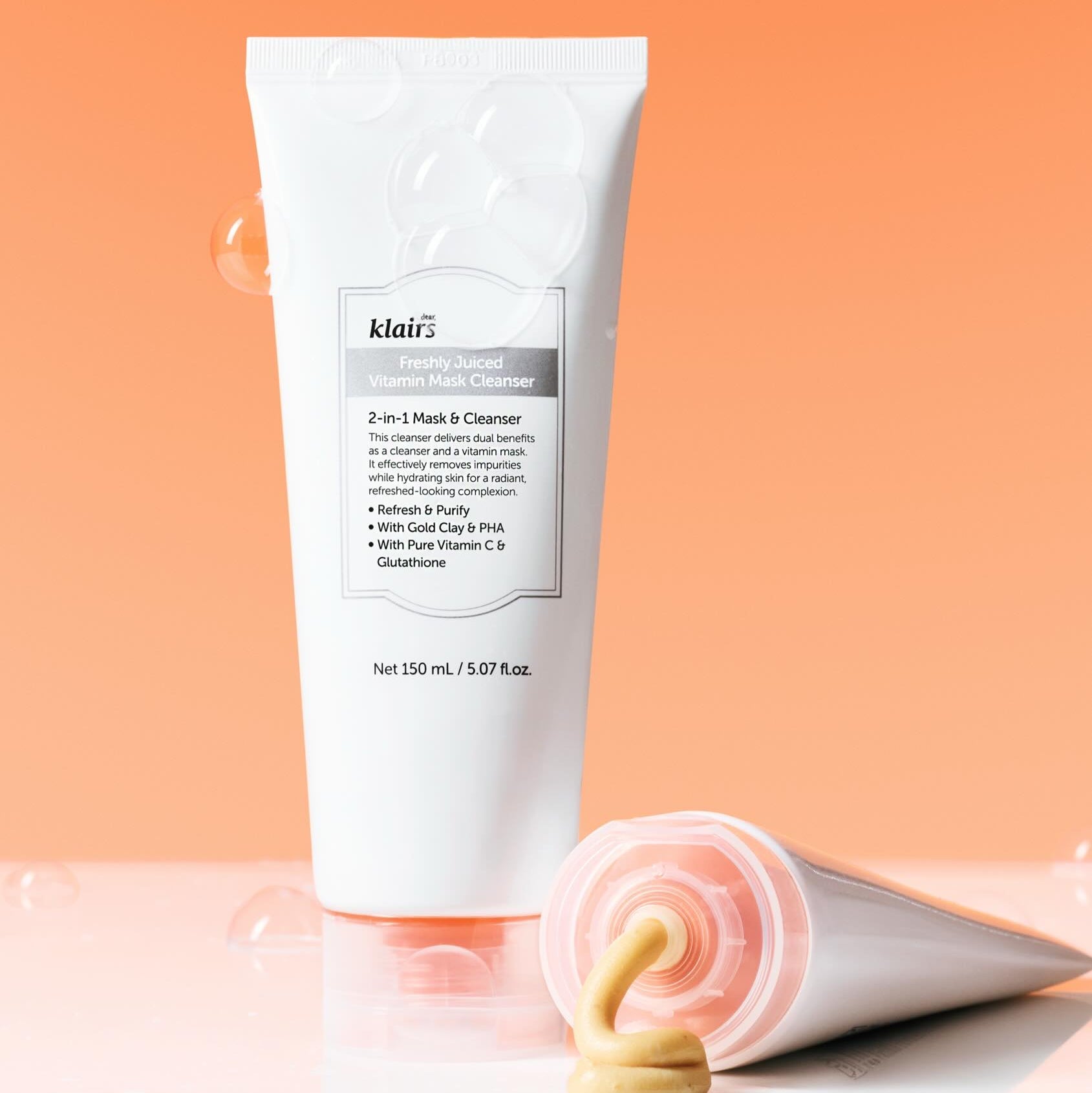 KLAIRS Freshly Juiced Vitamin Pack Cleanser 150ml with cleanser texture against orange background