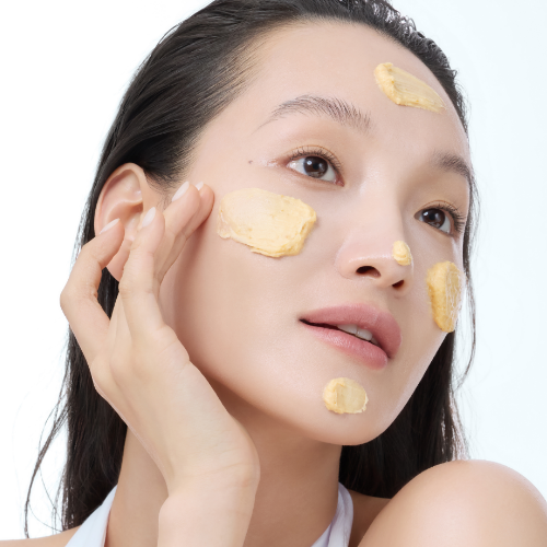 Model applying KLAIRS Freshly Juiced Vitamin Pack Cleanser 150ml to face, showcasing skincare routine for glowing skin.