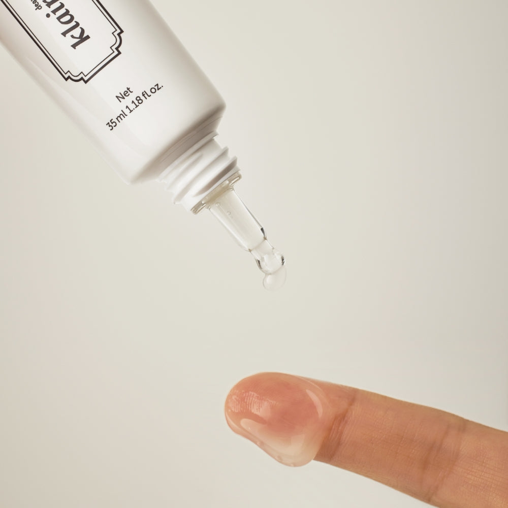 Applying KLAIRS Fundamental Eye Awakening Gel 35ml to fingertip from the tube.