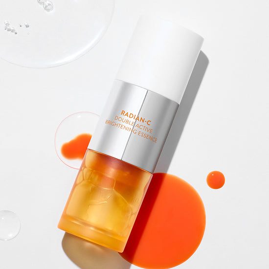 LANEIGE Radiance-C Double Active Brightening Essence 30g bottle on white background with spilled orange essence