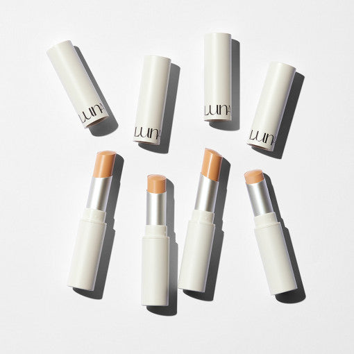 LUNA Pro Perfecting Stick Concealer collection with sleek white packaging and various nude shades for flawless makeup application.