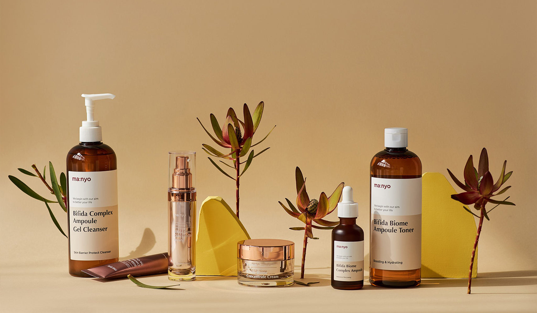 Skincare products displayed with natural elements on a neutral background.