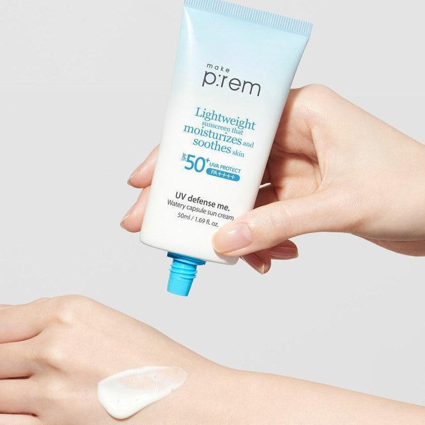 Person holding MAKE P:REM UV Defense Me Watery Capsule Sunscreen 50ml SPF50+ PA++++ next to hand with applied sunscreen.