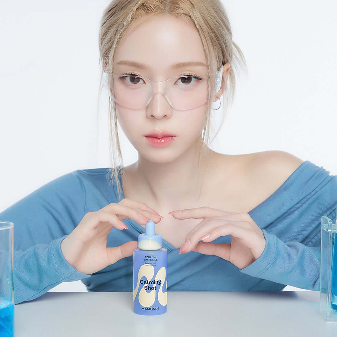 Woman holding MAMONDE Calming Shot Azulene Trace Moisture Ampoule 50ml, highlighting skincare benefits.