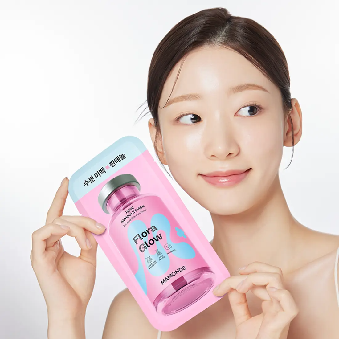 MAMONDE Flora Glow Rose Ampoule Mask Pack held by a woman with clear skin, highlighting skincare benefits.