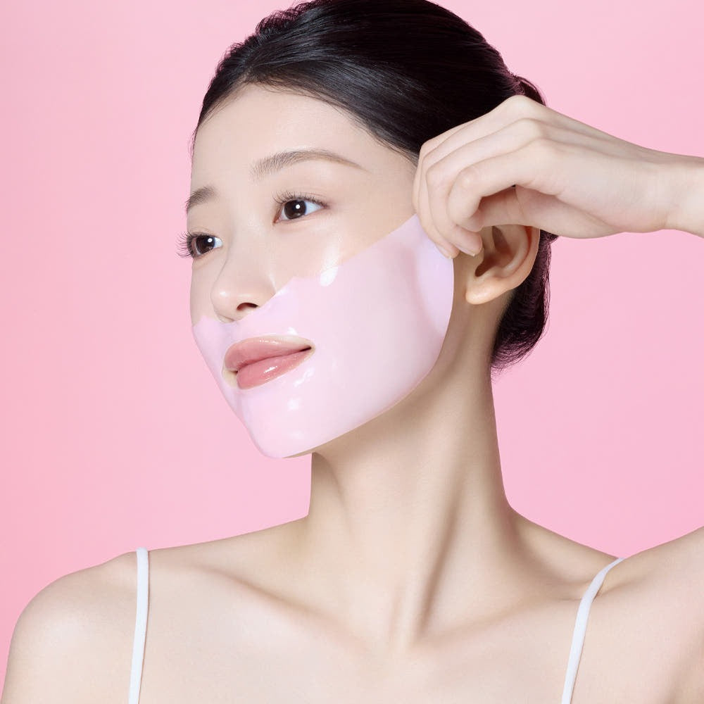 Woman applying MAMONDE Flora Glow Rose Hydrogel Mask 1 sheet on her face