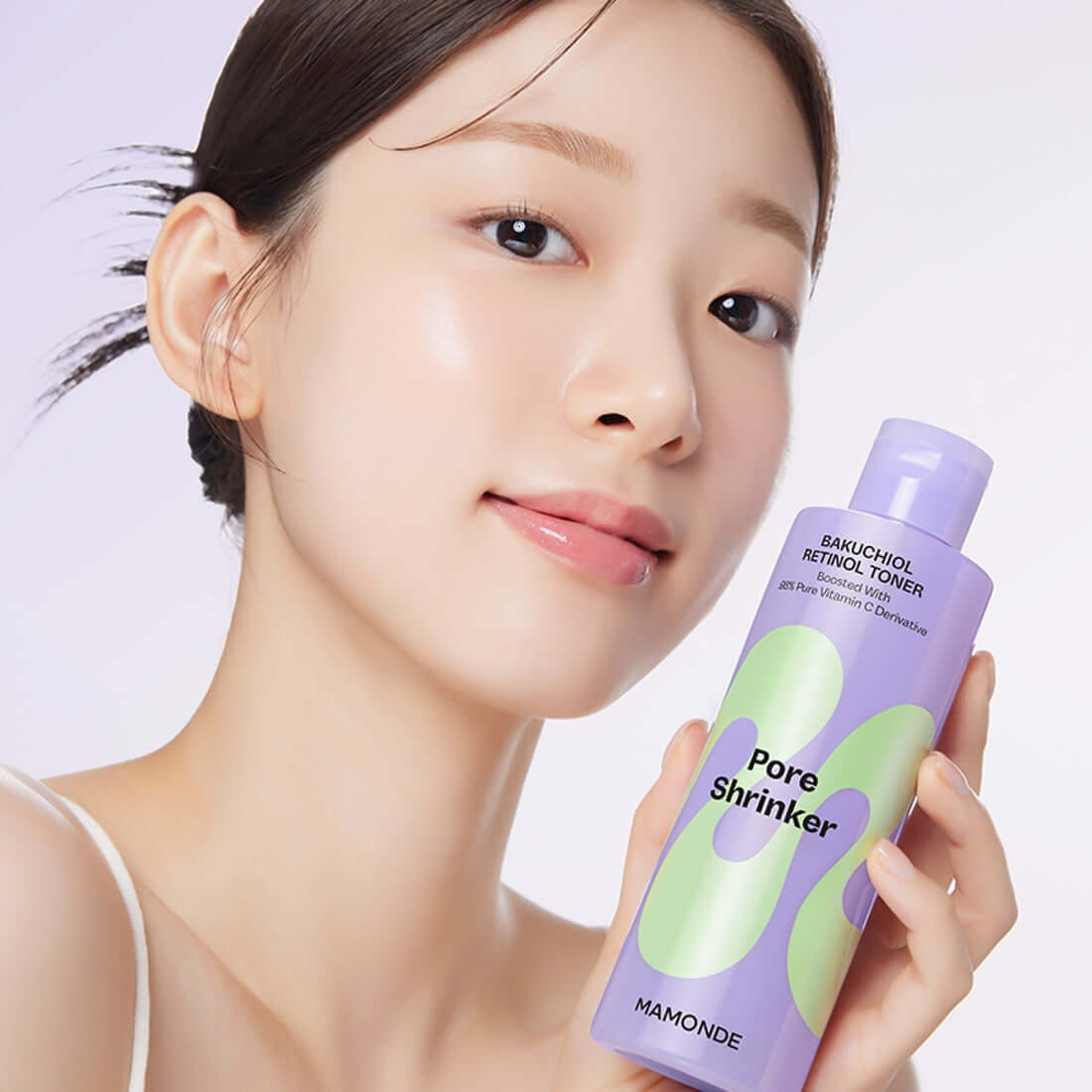 Woman holding MAMONDE Pore Shrinker Bakuchiol Retinol Toner 200ml bottle with radiant skin