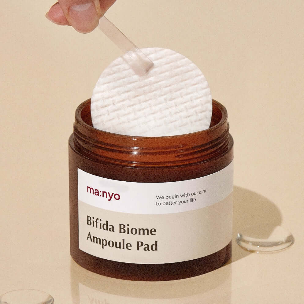 MANYO Bifida Biome Ampoule Pad 70 Sheets in jar, skincare product on beige background