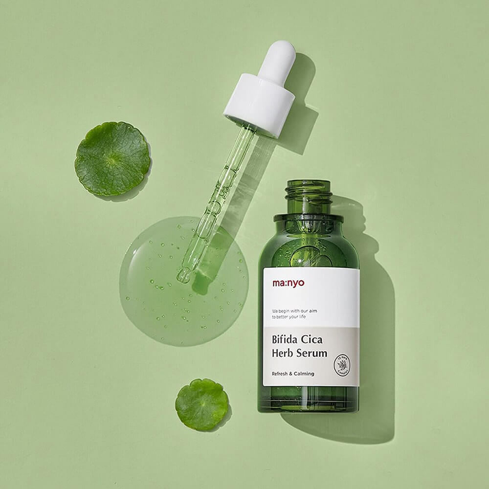 MANYO Bifida Cica Herb Serum 50ml bottle with dropper on green background showcasing skincare product.