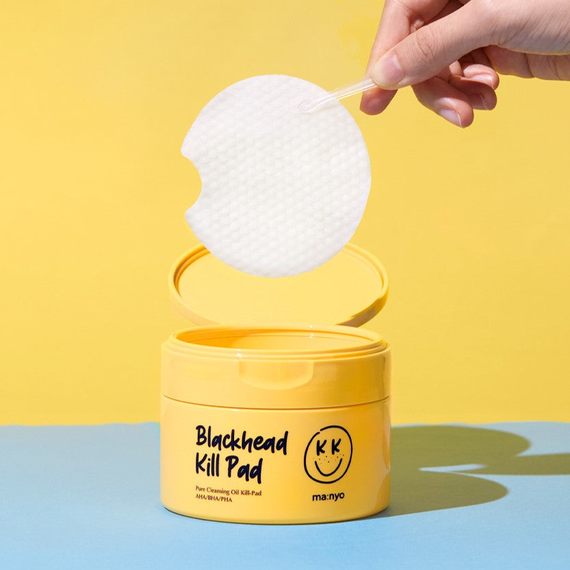 MA:NYO Blackhead Pure Cleansing Kill Pad 50p container with pad being lifted by a hand against a yellow background.