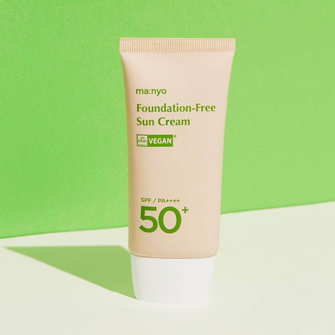 MA:NYO Vegan Foundation-Free Sun Cream SPF 50+ 50ml bottle against a green background