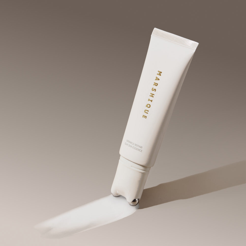 MARSHIQUE Wrinkle Repair Guasha Essence 45ml tube with applicator on a gradient background.