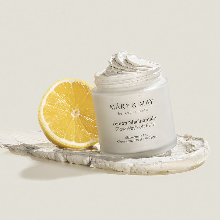 MARY & MAY Lemon Niacinamide Glow Wash off Pack 125g with a fresh lemon beside the product.