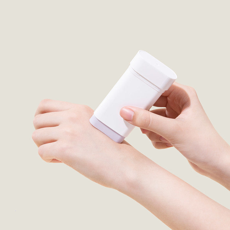 Hands applying MARY & MAY Vegan Peptide Bakuchiol Sun Stick on skin for sun protection