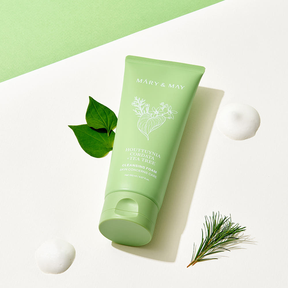 MARY&MAY Tea Tree Pore Cleansing Foam 150ml with natural ingredients, product image showing green tube next to botanical elements.