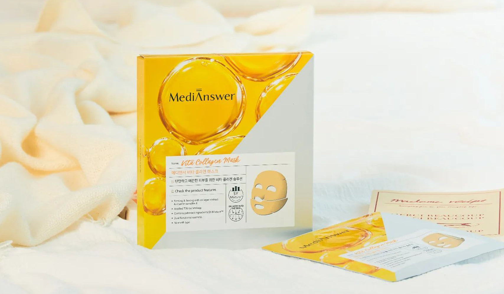 MediAnswer Vita Collagen Mask packaging on a soft fabric background, showcasing skincare product with vitamin collagen benefits.