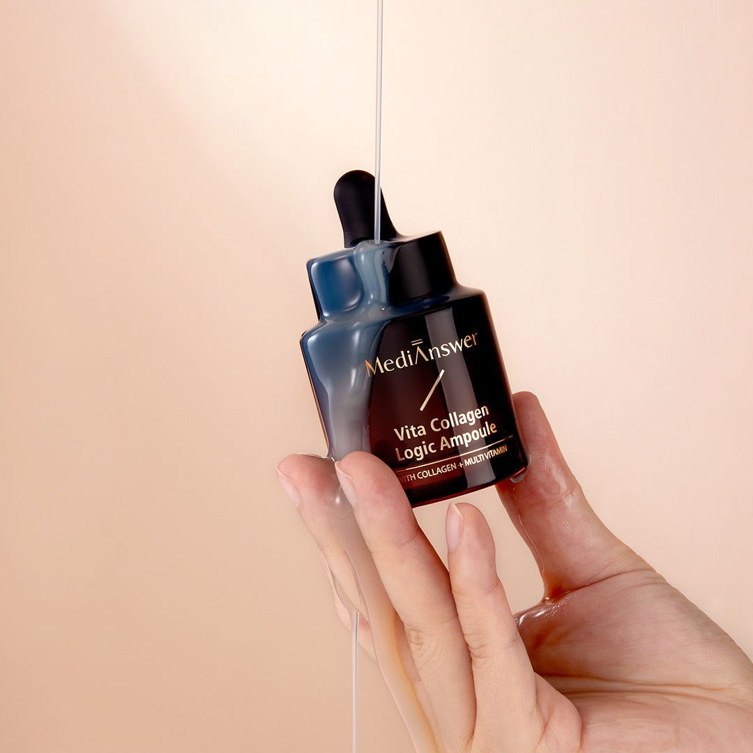 Hand holding MEDIANSWER Vita Collagen Logic Ampoule bottle on peach background