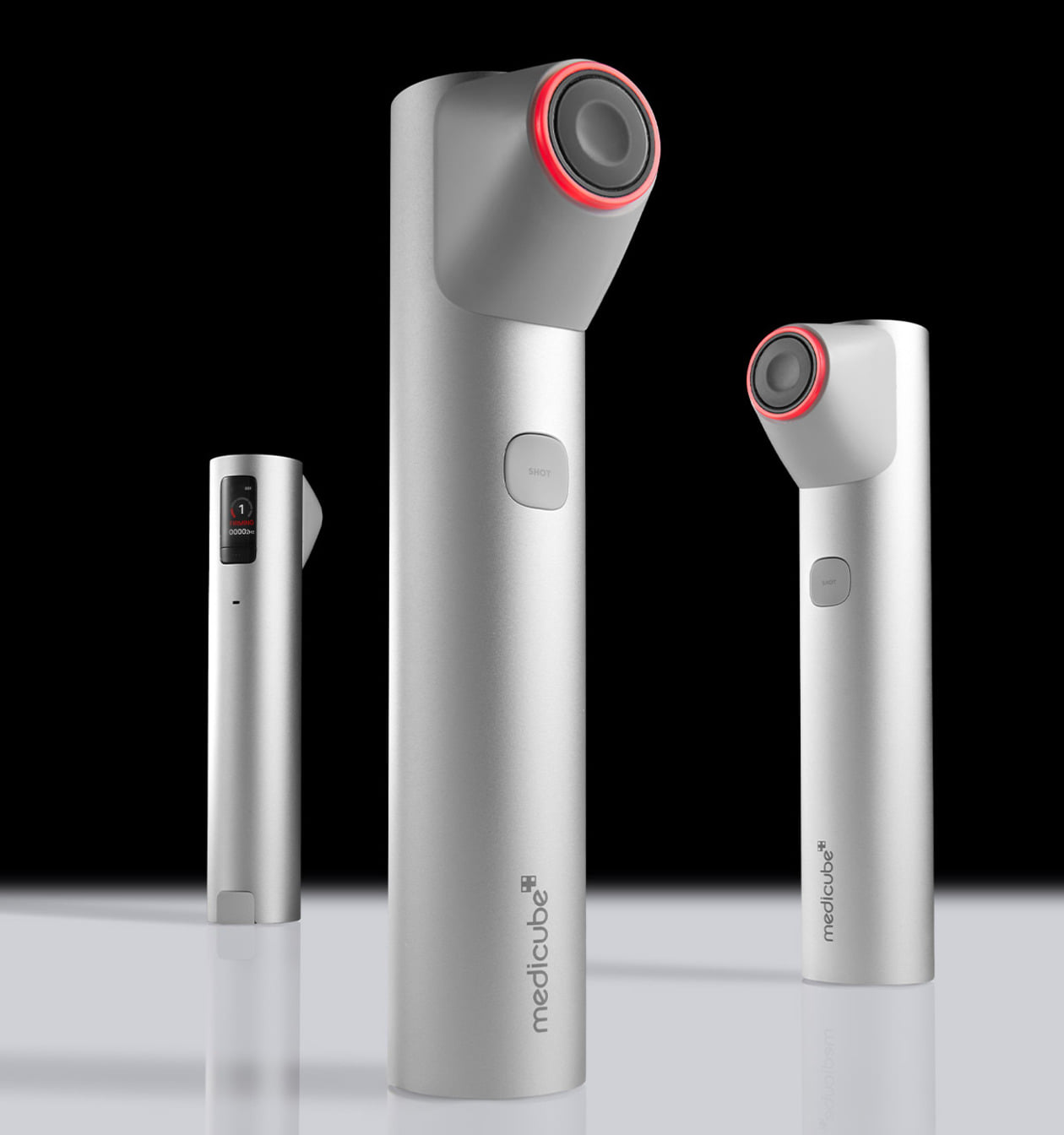 Three MEDICUBE AGE R High Focus Shot devices with sleek silver design and red accents displayed on a reflective surface.