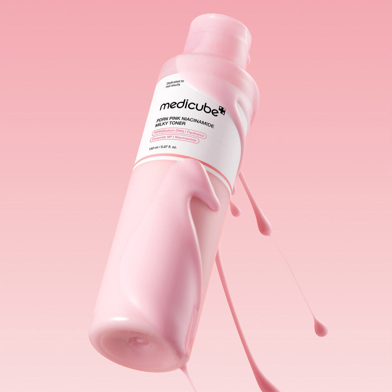 MEDICUBE PDRN Milky Toner Essence 150ml bottle against pink background
