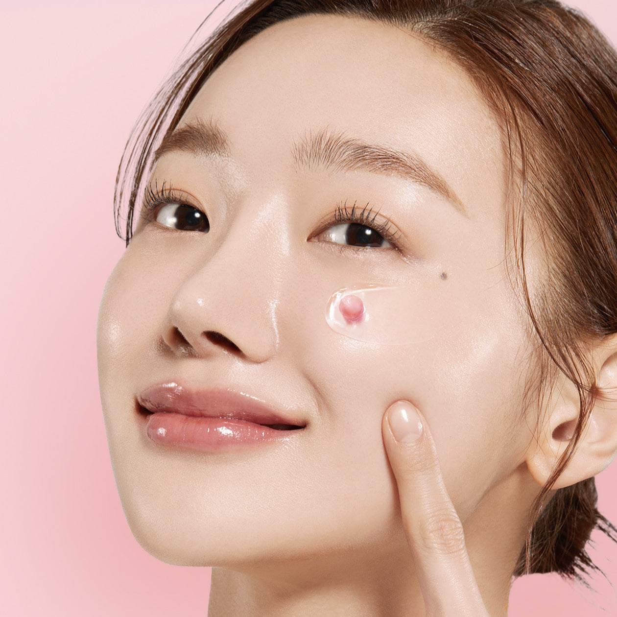 Woman applying MEDICUBE PDRN Pink Collagen Capsule Cream 55g on her face
