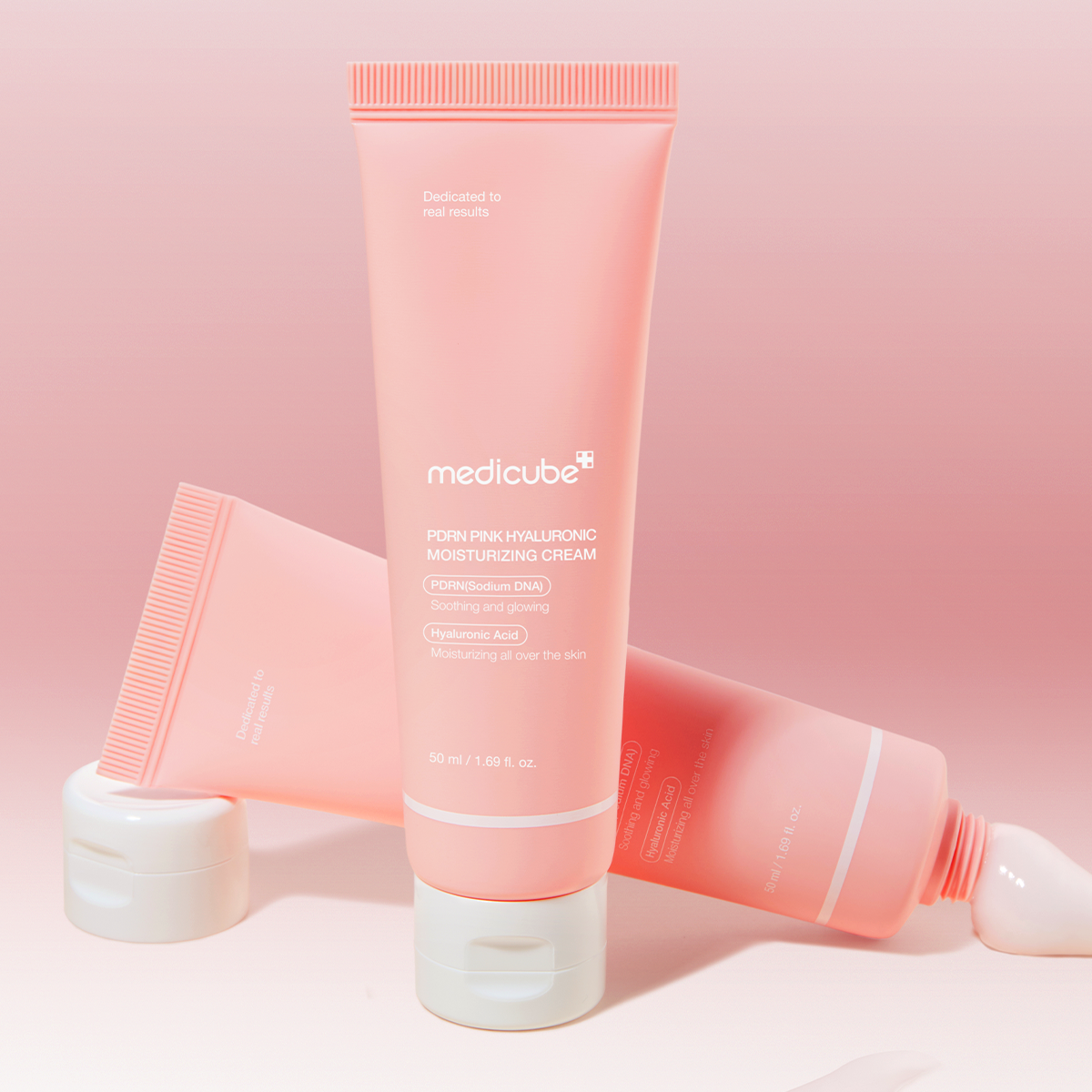 MEDICUBE PDRN Pink Hyaluronic Moisturizing Cream 50ml in a pink tube with white cap displayed against a matching pink background.