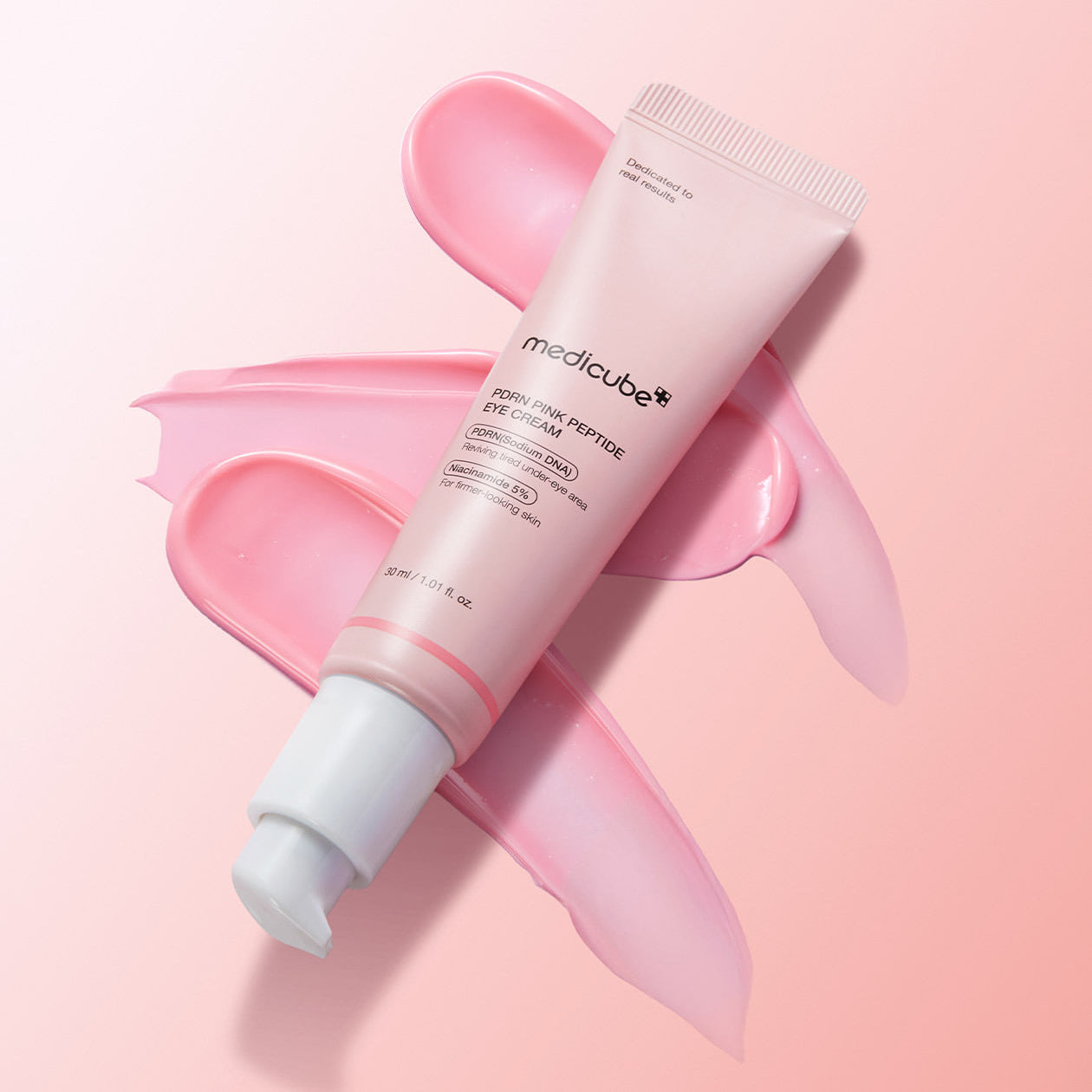MEDICUBE PDRN Pink Peptide Eye Cream 30ml tube with pink cream smear background