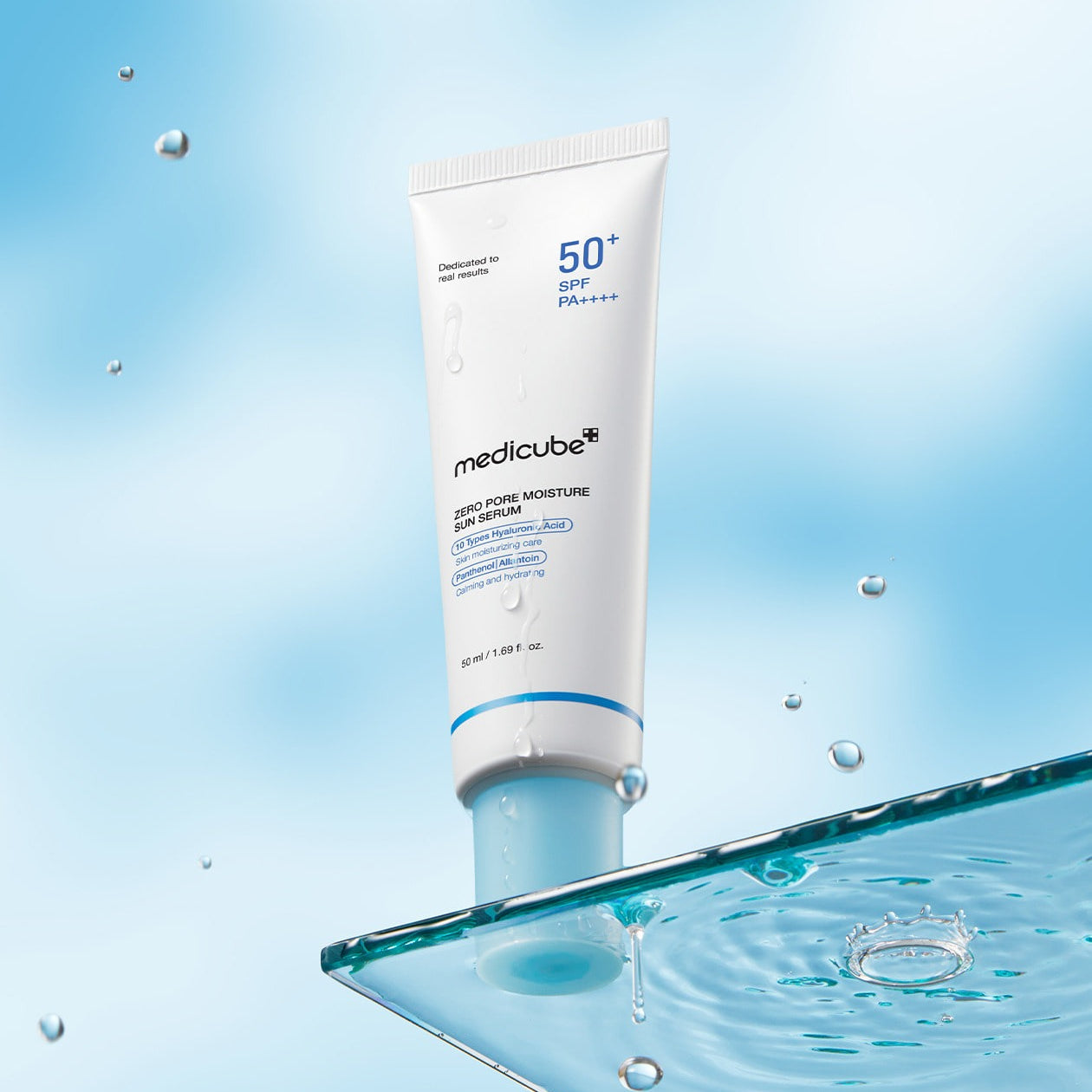 MEDICUBE Zero Pore Moisture Sun Serum 50ml with SPF 50+ on a reflective surface with water droplets