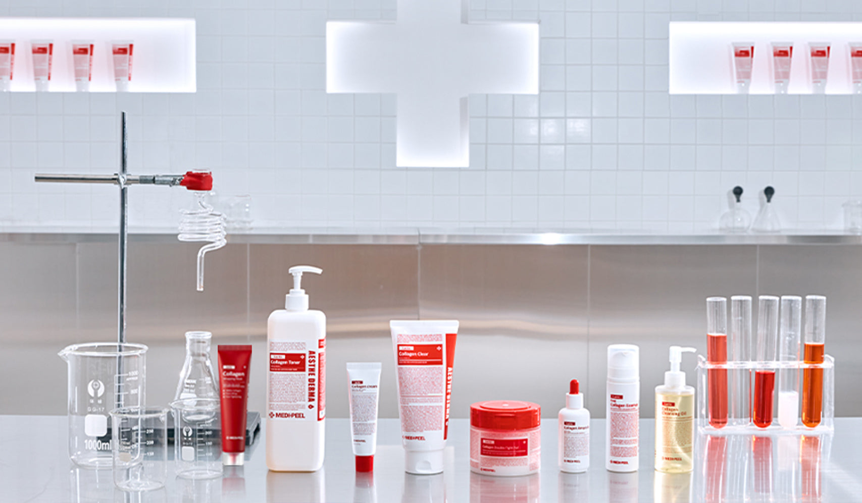 Skincare products and laboratory glassware displayed on a lab counter with a bright cross symbol in the background.