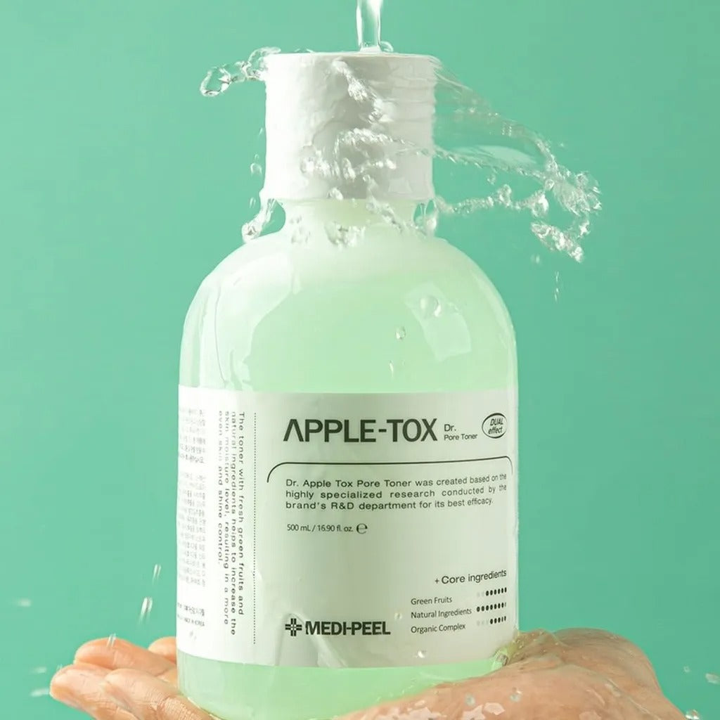 MEDIPEEL Dr.Apple Tox Pore Toner 500ml held in hand with water splashing