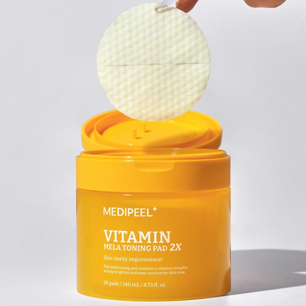 MEDIPEEL Vitamin Mela Toning Pads 2X 140ml 50sheets in yellow packaging with a pad being lifted out of the container.