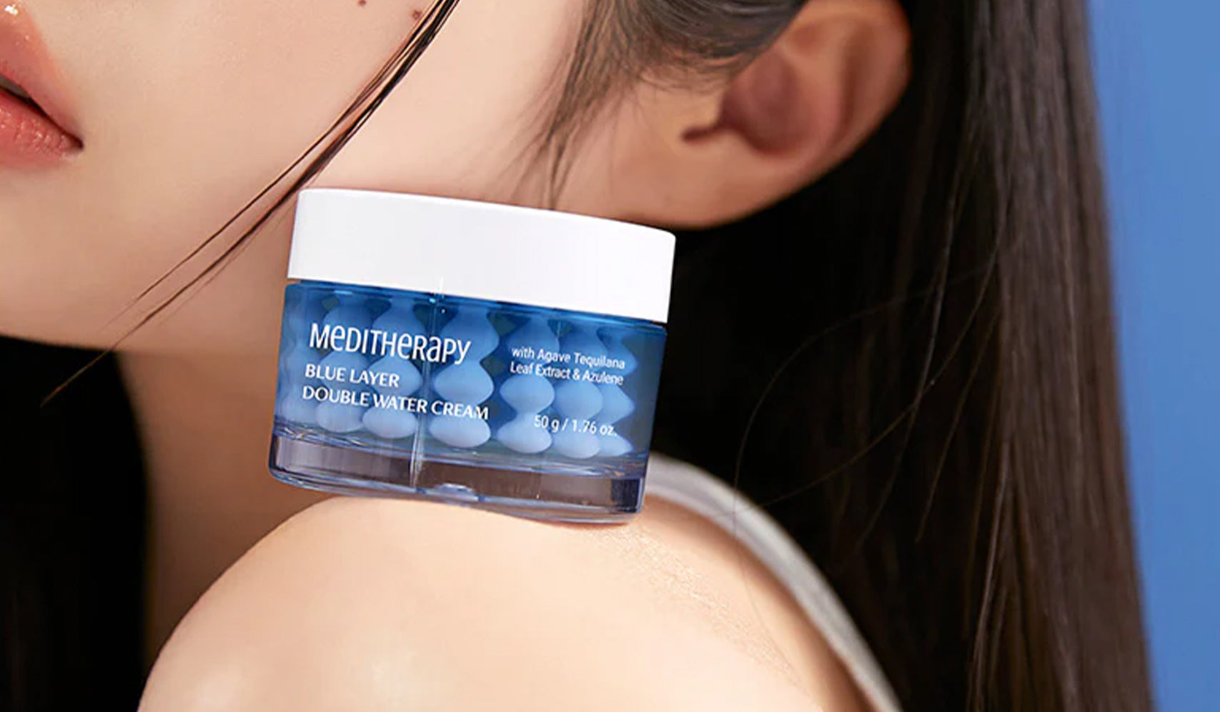 Medi Therapy Blue Layer Double Water Cream jar on shoulder with hydrating skincare focus