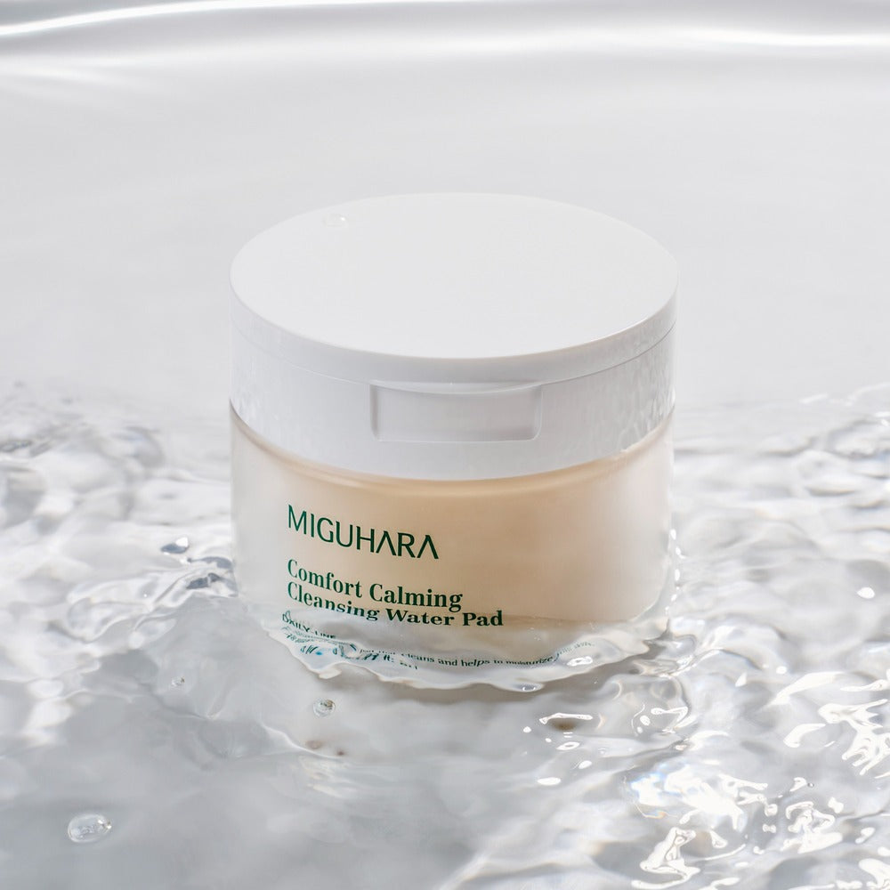 MIGUHARA Comfort Calming Cleansing Water Pads 70 Sheets in water, showcasing the soothing and cleansing properties of the product.