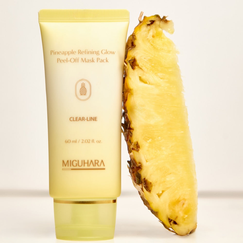 MIGUHARA Pineapple Refining Glow Peel Off Mask Pack 60ml next to a fresh pineapple slice, highlighting skincare benefits.