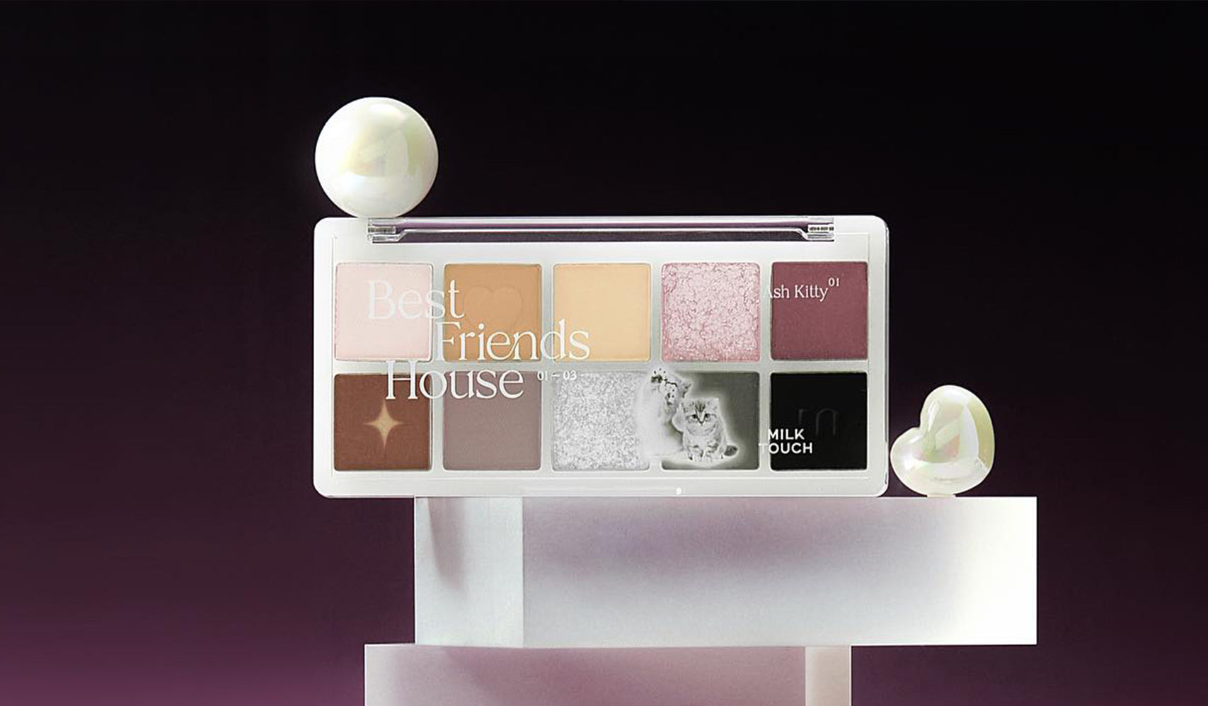 Makeup palette with pastel and neutral eyeshadows displayed artistically on modern geometric stands against a dark background.