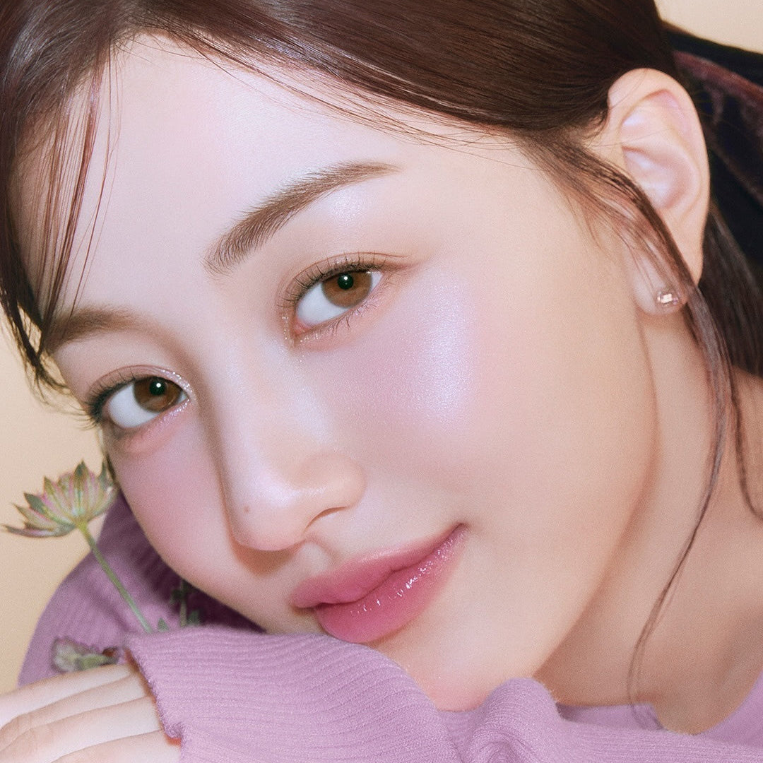 Model wearing MILK TOUCH Tone On Blusher showcasing natural rosy cheeks with a soft focus effect.