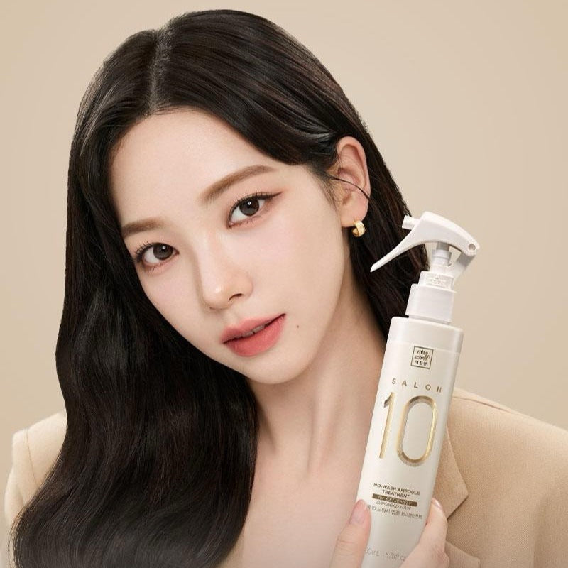 Woman holding MISE EN SCENE Salon 10 No-Wash Extreme Damage Ampoule Treatment 200ml bottle.