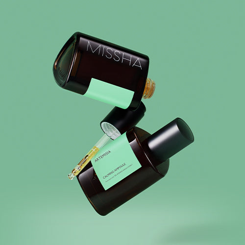 MISSHA Artemisia Calming Ampoule 75ml in floating bottles with green labels on a green background.