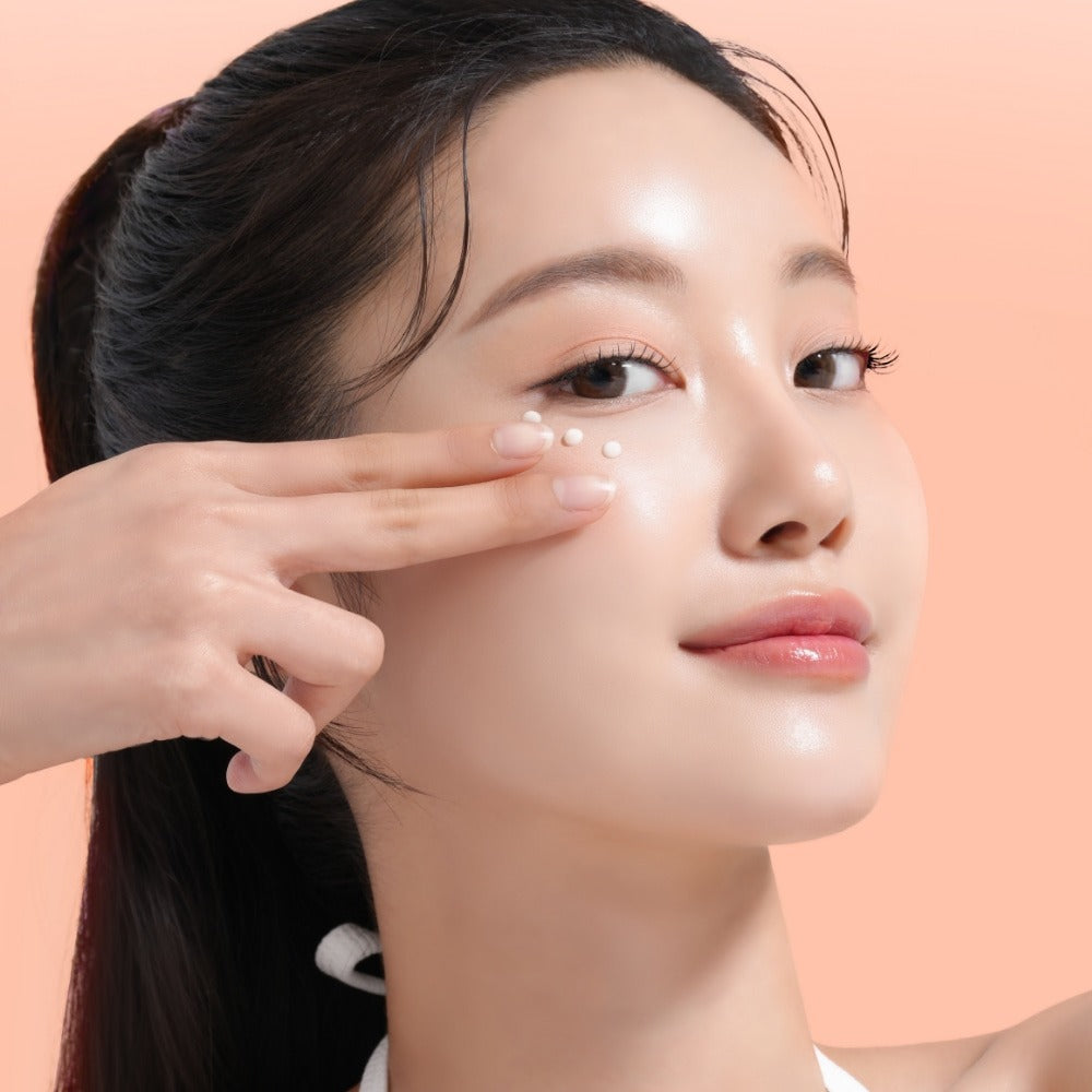 Woman applying MIXSOON PDRN Collagen Eye Serum 20ml around eyes on clear skin