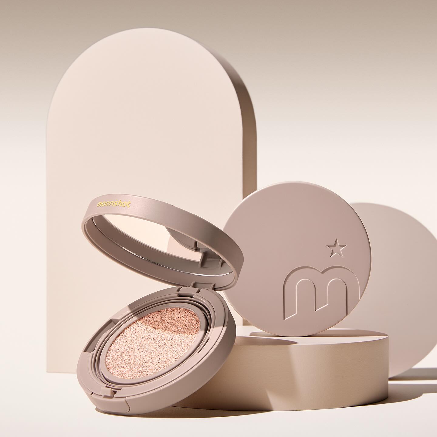 MOONSHOT Conscious Fit Cushion Foundation in open compact case with beige background