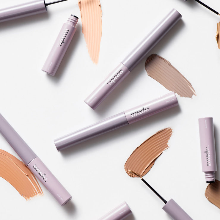 MUDE Inspire Skinny Brow Cara tubes with brow swatches showcasing color options.