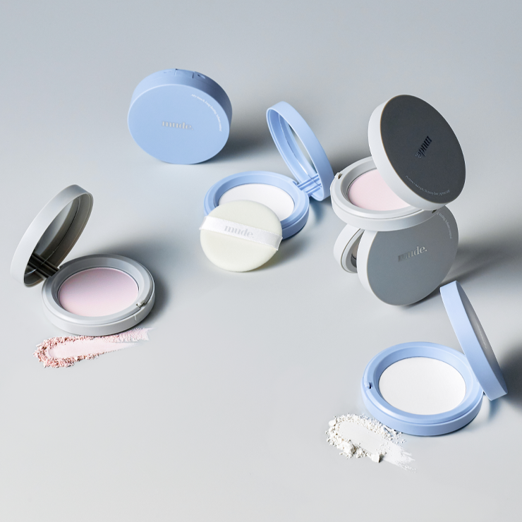 Assorted MUDE Settingn Powder Patch compacts displayed on a light surface.