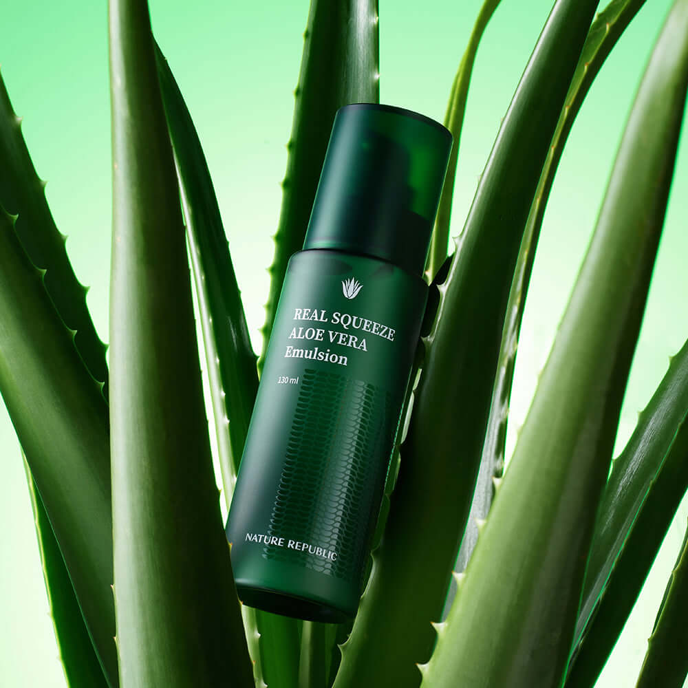 NATURE REPUBLIC Real Squeeze Aloe Vera Emulsion 130ml with green aloe vera leaves in the background.