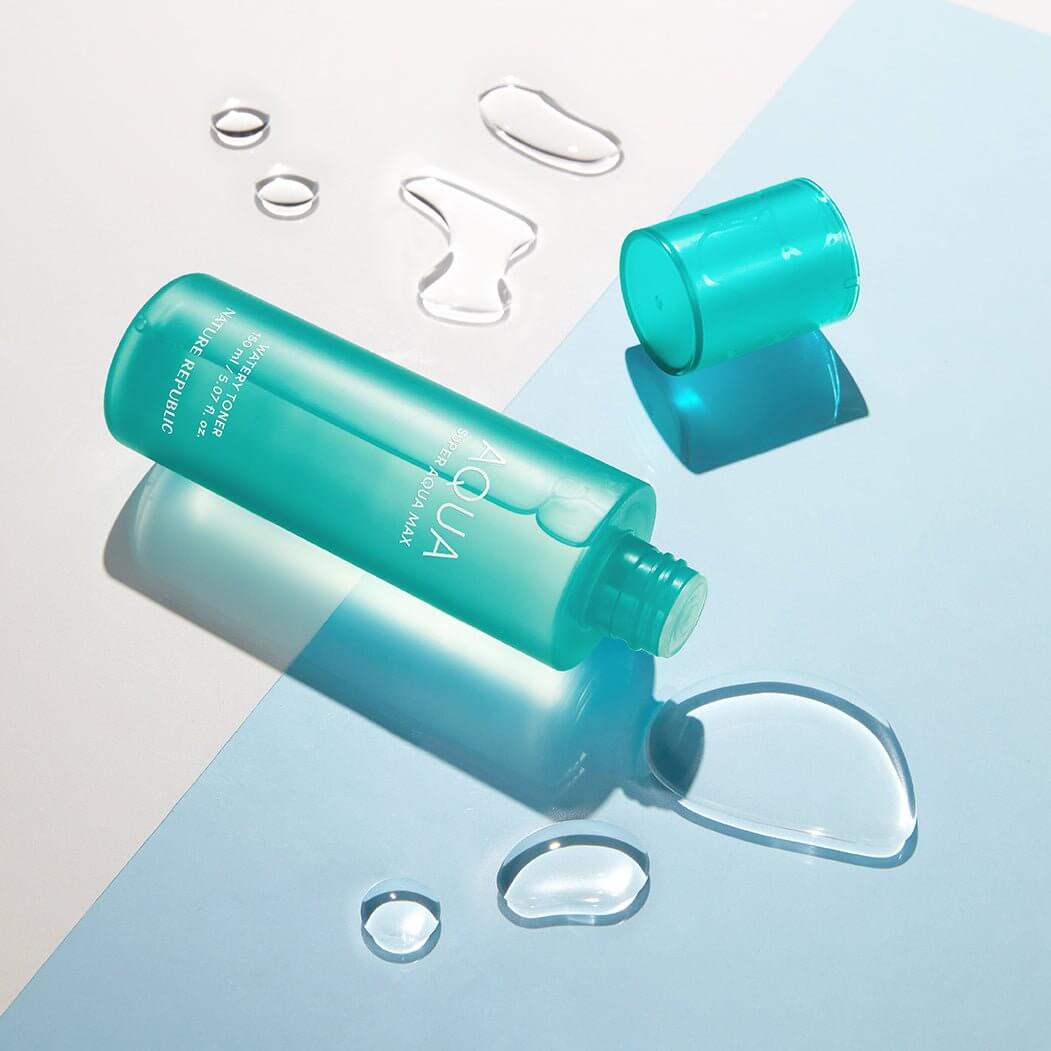NATURE REPUBLIC Super Aqua Max Watery Toner 150ml bottle on a light background with water droplets, showcasing hydration essence.