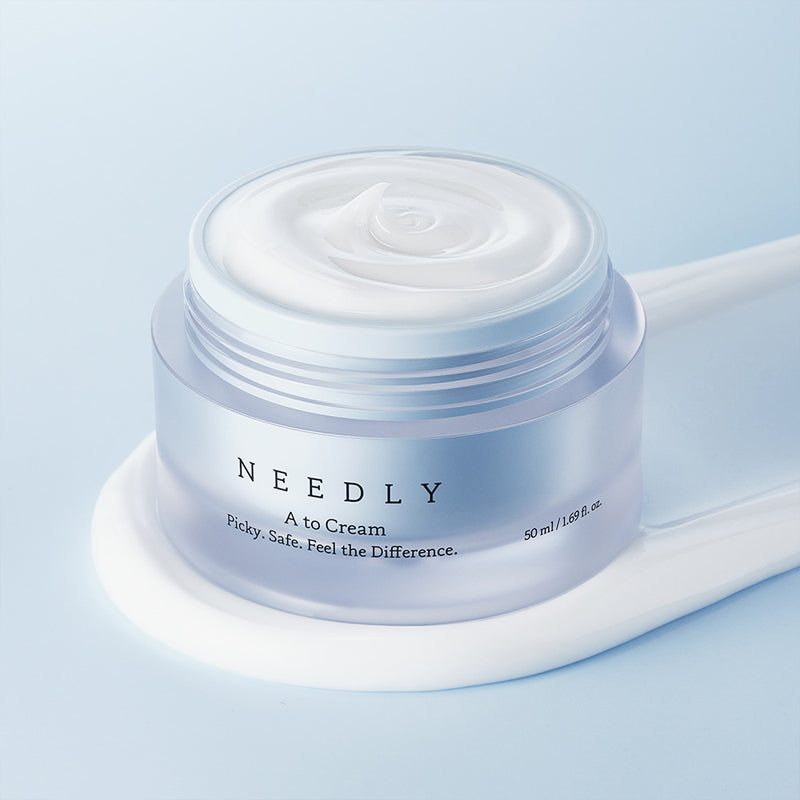 NEEDLY A to Cream 50ml moisturizing jar on blue background
