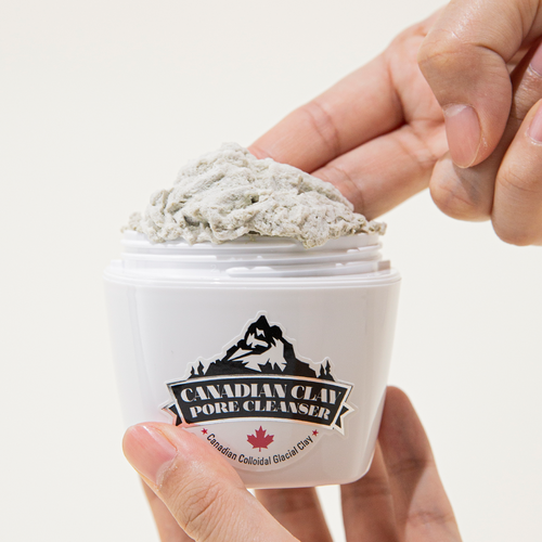 Close-up of NEOGEN Canadian Clay Pore Cleanser 120g being applied from container with hand, showcasing texture and packaging.