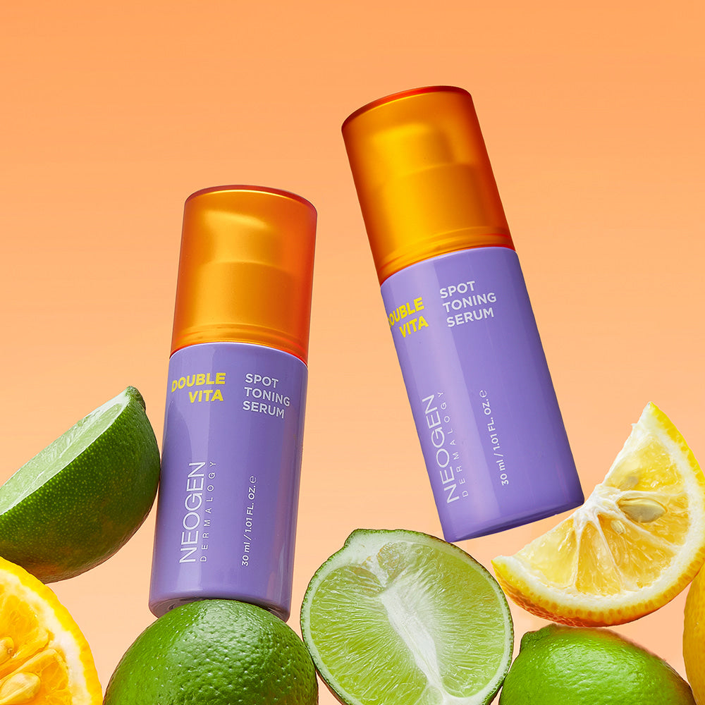 NEOGEN Double Vita Spot Toning Serum 30ml with citrus fruits on an orange background