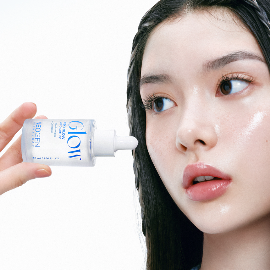 Woman applying NEOGEN Next Glow Prep Serum 32ml to face, highlighting radiant skin benefits.