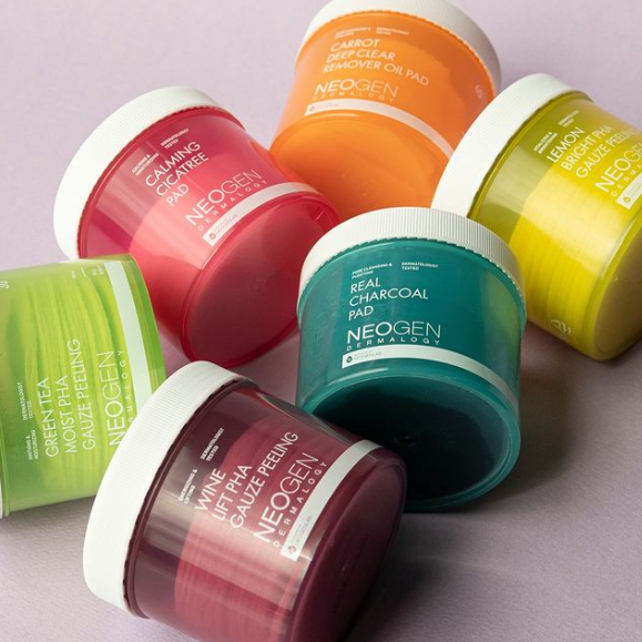 Assorted NEOGEN skincare pads on display including NEOGEN Pad 150ml Lemon Bright PHA Gauze and others.